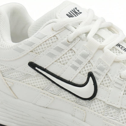 ATLAS. — A lace-up sneaker with layered panels and a raised sole.