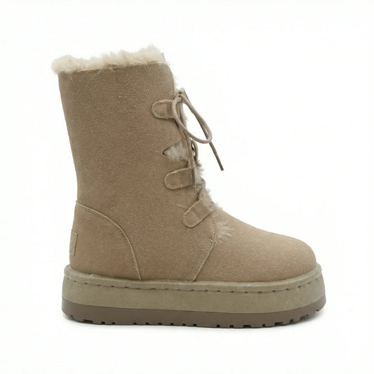 TKN Sahara silhouette in Sand Camel featuring a high-top lace-up design with plush shearling lining and a platform sole.