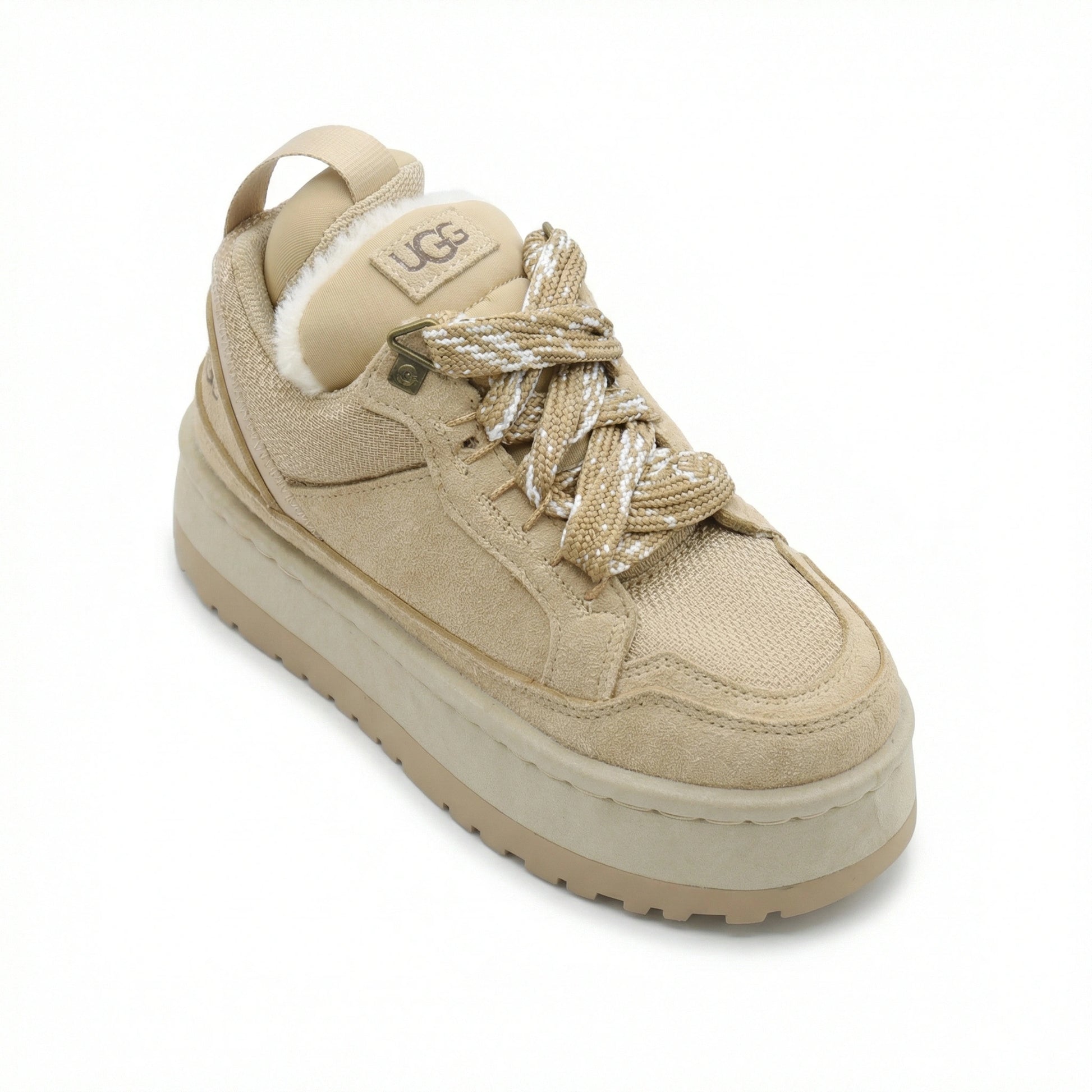 Close-up of TKN Dune Platform showing technical rope laces, metallic hardware, and plush shearling lining