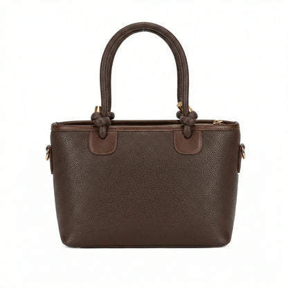Onyx — A structured tote with knotted top handles and metal-tone details.