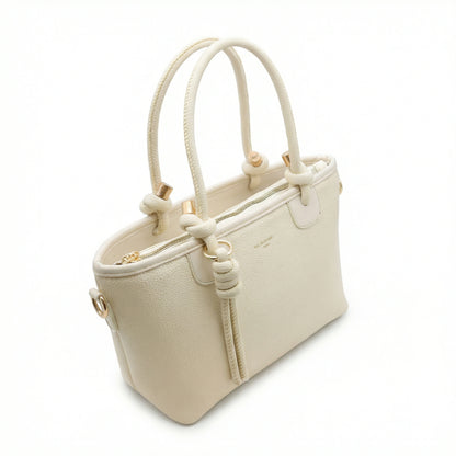 Onyx — A structured tote with knotted top handles and metal-tone details.