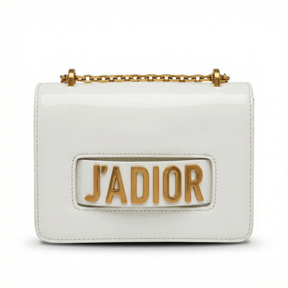 Quartz — A compact flap-style crossbody bag with a chain strap and metal accent.