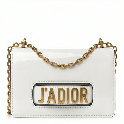 Quartz — A compact flap-style crossbody bag with a chain strap and metal accent.