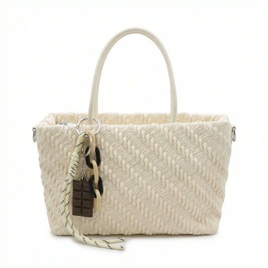 TKN Mousse cream handbag featuring textured ruched vegan leather, matte monochromatic chain charm, and dimensions of 24x16x9cm