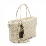 Mousse — A top-handle bag with a gathered-look finish and chain accent.