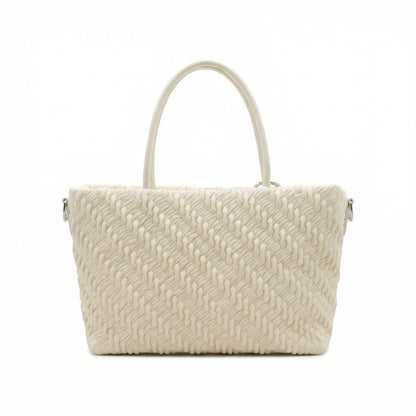 Mousse — A top-handle bag with a gathered-look finish and chain accent.