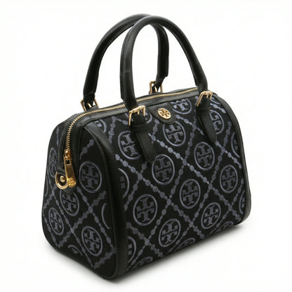 Legacy — A structured Boston bag with rounded top handles and an all-over pattern.