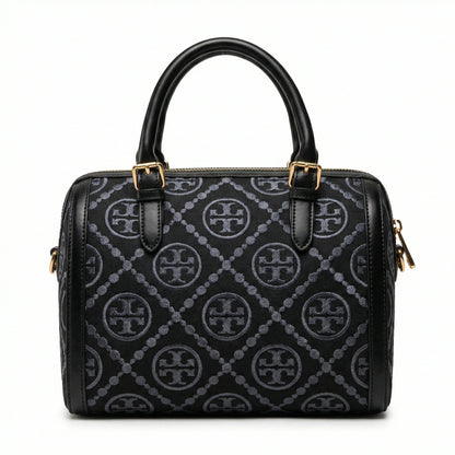 Legacy — A structured Boston bag with rounded top handles and an all-over pattern.