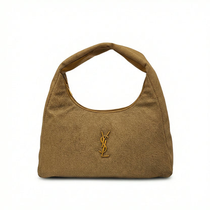 Eclipse — A curved shoulder bag with a textured finish and small metal detail.