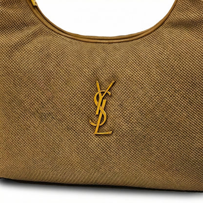 Eclipse — A curved shoulder bag with a textured finish and small metal detail.