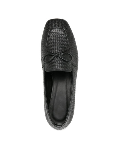 TKN Camille black woven-effect loafer with a tonal bow and piped vamp panel — top view.