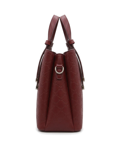 TKN Emblem — Burgundy — upright structured-looking body — side profile.