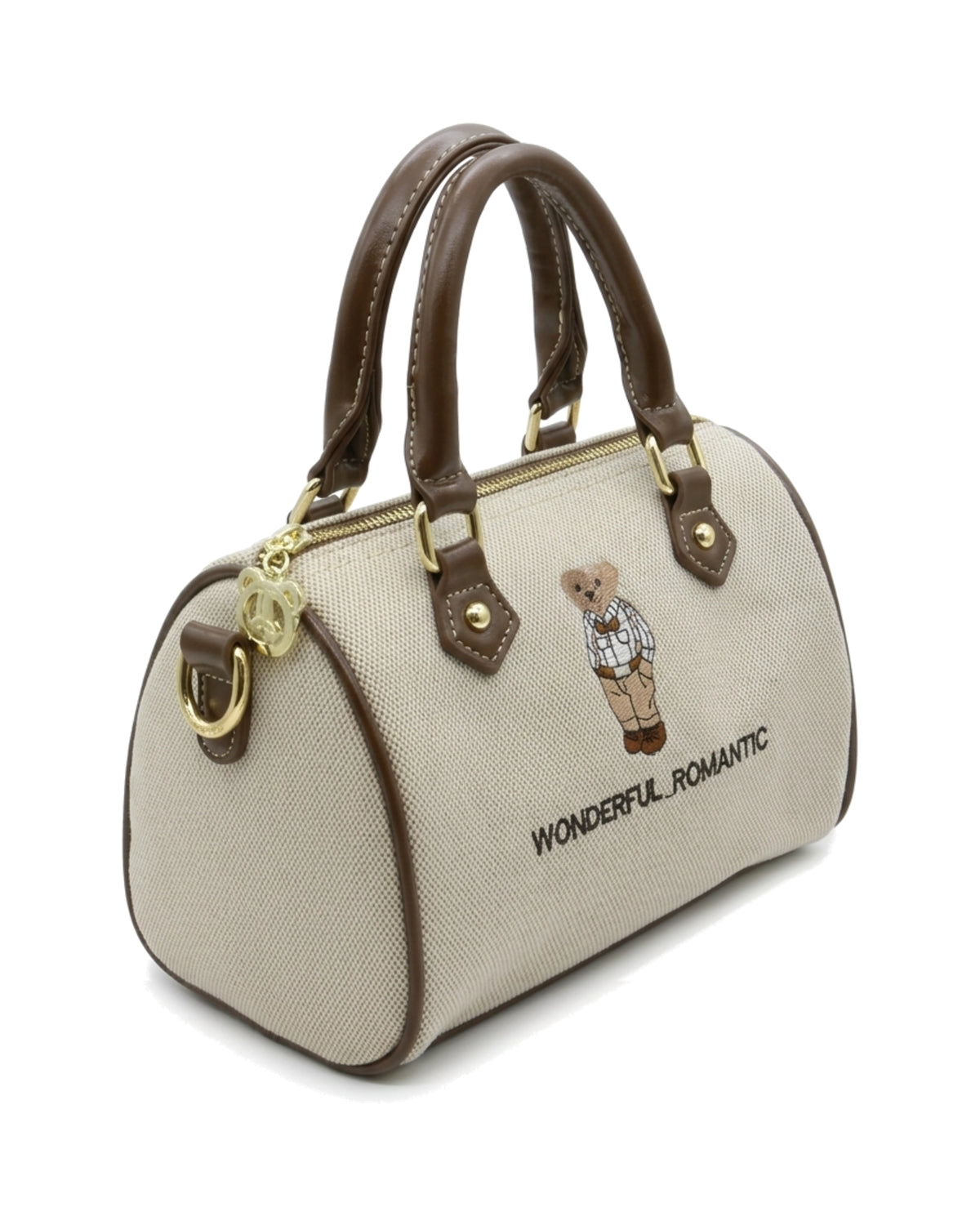 TKN Keepsake — Cream / Brown — rounded boston-style body — front three-quarter view.