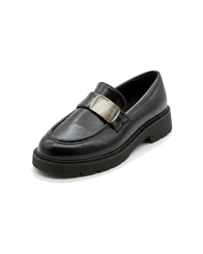 TKN Margot black chunky loafer with a silver-tone metal plaque — front three-quarter view.