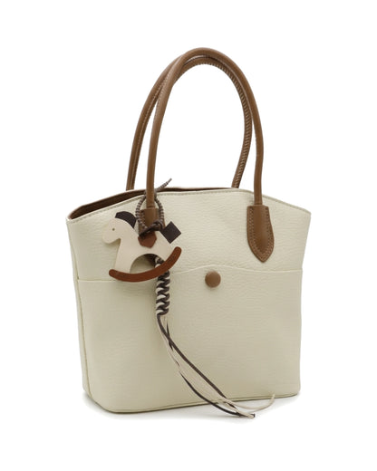 TKN Whim — Cream / Brown — gently tapered tote shape — front three-quarter view.